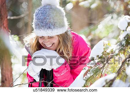 Young adult woman among snow-covered tree branches View Large Photo Image Stock Photo - Young adult woman among snow-covered tree branches. Fotosearch