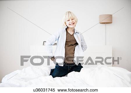 Young boy playing on bed View Large Photo Image Stock Photography - Young boy playing on bed. Fotosearch
