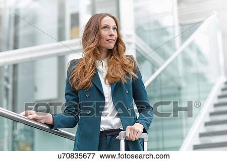Stock Photo - Young business woman on modern exterior staircase. Fotosearch