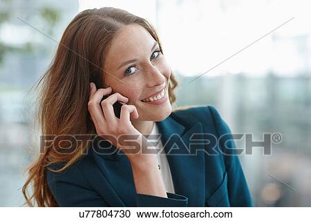 Young business woman using smartphone View Large Photo Image Stock Image - Young business woman using smartphone. Fotosearch