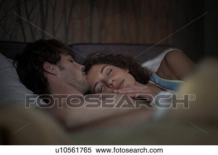 Young couple in bed View Large Photo Image Stock Photography - Young couple in bed. Fotosearch