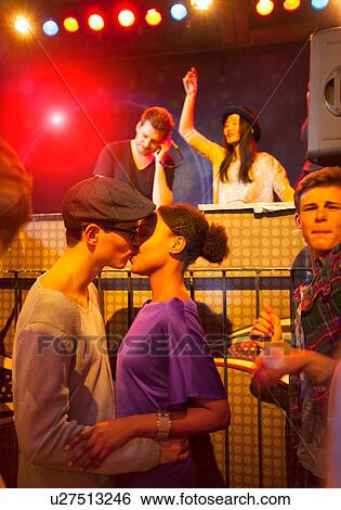 Young couple kissing at party, disc jockey in background View Large Photo Image Stock Photograph - Young couple kissing at party, disc jockey in background. Fotosearch