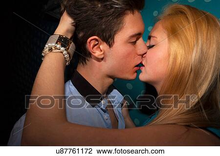 Stock Image - Young couple kissing. Fotosearch