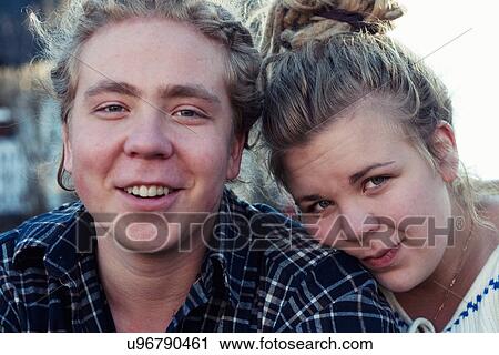 Young couple looking at camera View Large Photo Image Stock Image - Young couple looking at camera. Fotosearch