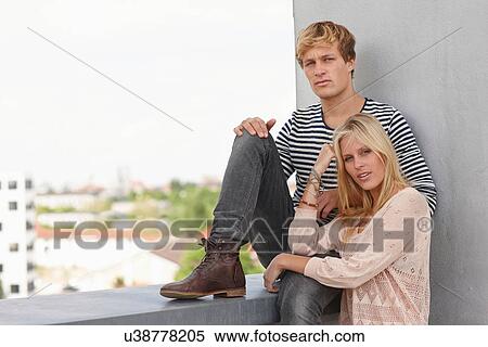 Young couple on apartment balcony View Large Photo Image Stock Photography - Young couple on apartment balcony. Fotosearch