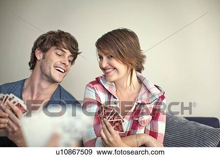 Stock Photo - Young couple playing cards. Fotosearch