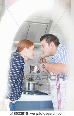 Young couple smelling cooking aroma from saucepan View Large Photo Image Stock Photo - Young couple smelling cooking aroma from saucepan. Fotosearch