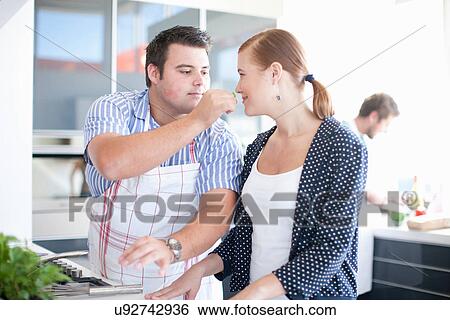 Young couple smelling herbs View Large Photo Image Stock Photograph - Young couple smelling herbs. Fotosearch