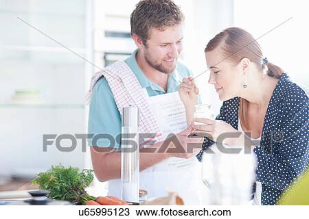 Stock Image - Young couple smelling ingredients. Fotosearch