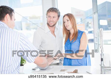 Young couple talking with salesman in kitchen showroom View Large Photo Image Stock Photography - Young couple talking with salesman in kitchen showroom. Fotosearch