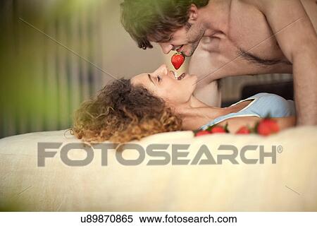 Stock Photography - Young couple with strawberries. Fotosearch