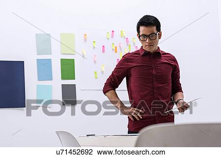 Young male preparing work in design studio View Large Photo Image Stock Image - Young male preparing work in design studio. Fotosearch