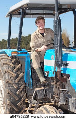Young man driving tractor View Large Photo Image Stock Photo - Young man driving tractor. Fotosearch