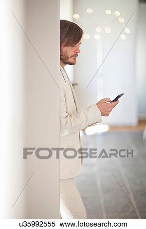 Stock Photography - Young man using cell phone. Fotosearch