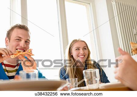 Young people eating pizza View Large Photo Image Stock Photograph - Young people eating pizza. Fotosearch