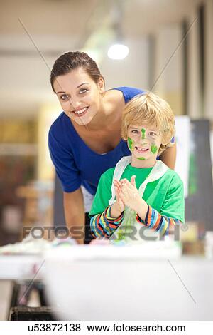 Stock Photo - Young woman and boy in art class. Fotosearch