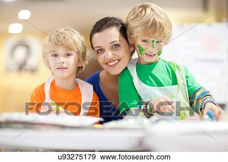 Stock Photo - Young woman and boys in art class. Fotosearch