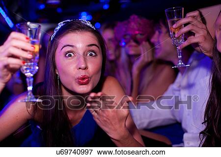 Young woman blowing kiss in limousine View Large Photo Image Stock Photo - Young woman blowing kiss in limousine. Fotosearch