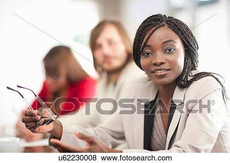 Young woman holding glasses View Large Photo Image Stock Photo - Young woman holding glasses. Fotosearch