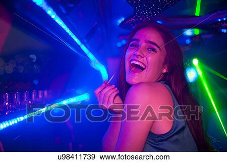 Young woman laughing at bar in nightclub View Large Photo Image Stock Photo - Young woman laughing at bar in nightclub. Fotosearch