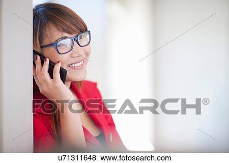 Young woman on cell phone View Large Photo Image Stock Photo - Young woman on cell phone. Fotosearch