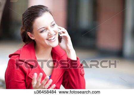 Picture - Young woman on cellphone. Fotosearch