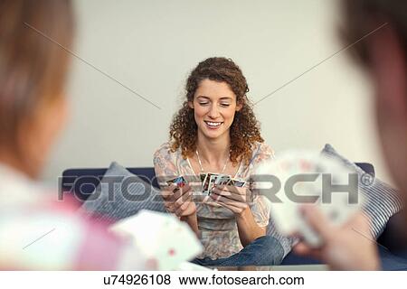 Stock Photo - Young woman playing cards. Fotosearch