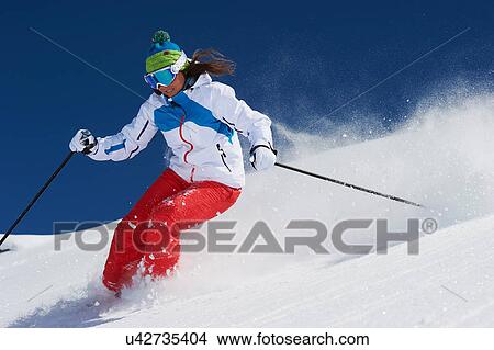 Picture - Young woman skiing. Fotosearch