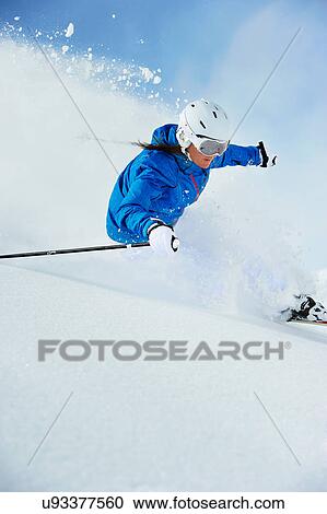 Stock Image - Young woman skiing. Fotosearch