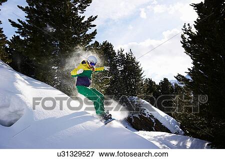 Stock Photo - Young woman snowboarding. Fotosearch