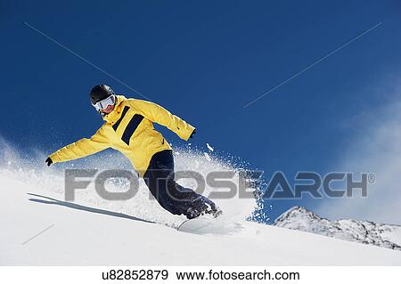 Young woman snowboarding View Large Photo Image Stock Photo - Young woman snowboarding. Fotosearch