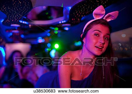 Young woman wearing bunny ears in limousine View Large Photo Image Stock Image - Young woman wearing bunny ears in limousine. Fotosearch