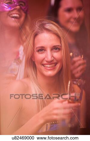 Young woman with blonde hair holding wine glass View Large Photo Image Stock Image - Young woman with blonde hair holding wine glass. Fotosearch