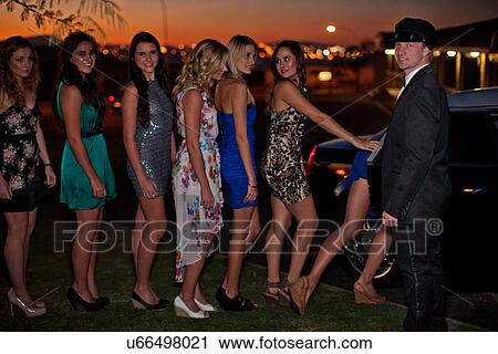 Young women getting into limousine with chauffeur View Large Photo Image Stock Image - Young women getting into limousine with chauffeur. Fotosearch
