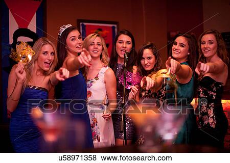 Young women singing in karaoke bar View Large Photo Image Stock Photo - Young women singing in karaoke bar. Fotosearch
