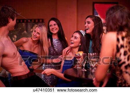 Young women watching male stripper at hen party View Large Photo Image Stock Image - Young women watching male stripper at hen party. Fotosearch