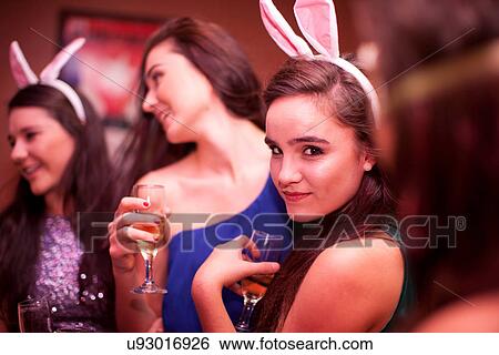 Young women wearing bunny ears at hen party View Large Photo Image Stock Photograph - Young women wearing bunny ears at hen party. Fotosearch