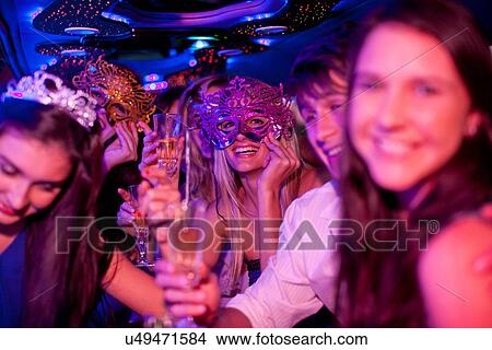 Young women wearing masks in limousine View Large Photo Image Picture - Young women wearing masks in limousine. Fotosearch