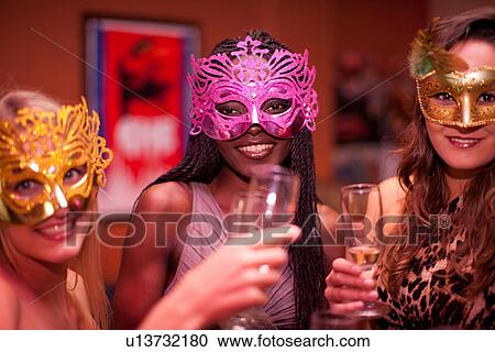 Young women wearing masquerade masks at hen party View Large Photo Image Stock Image - Young women wearing masquerade masks at hen party. Fotosearch