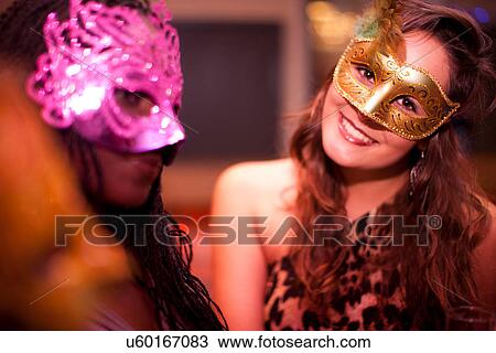 Young women wearing masquerade masks at hen party View Large Photo Image Stock Image - Young women wearing masquerade masks at hen party. Fotosearch