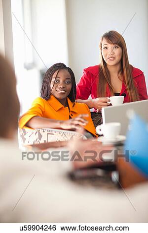 Young women with laptop and coffee View Large Photo Image Stock Photograph - Young women with laptop and coffee. Fotosearch