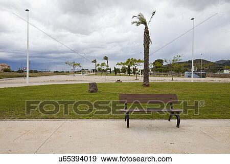 Bench in park with stormy sky, Valencia region, Spain View Large Photo Image Stock Photo - Bench in park with stormy sky, Valencia region, Spain. Fotosearch