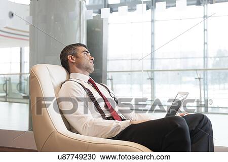 Bored businessman stares out window View Large Photo Image Stock Image - Bored businessman stares out window. Fotosearch