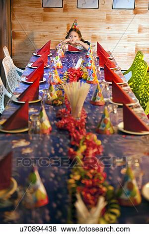 Bored young girl at head of fully set but empty birthday table View Large Photo Image Stock Photo - Bored young girl at head of fully set but empty birthday table. Fotosearch