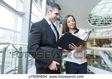 Businessman and woman discussing work View Large Photo Image Picture - Businessman and woman discussing work. Fotosearch