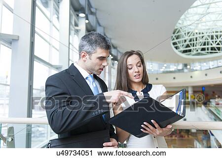 Businessman and woman discussing work View Large Photo Image Stock Image - Businessman and woman discussing work. Fotosearch