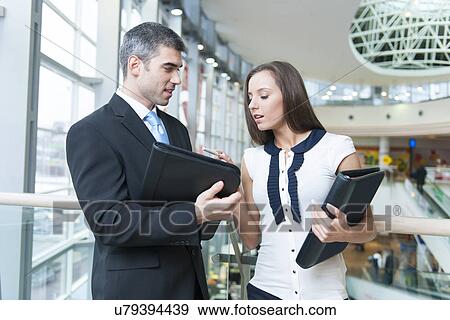 Businessman and woman discussing work View Large Photo Image Stock Photo - Businessman and woman discussing work. Fotosearch