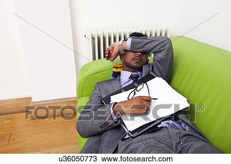 Businessman sleeping on a sofa View Large Photo Image Stock Image - Businessman sleeping on a sofa. Fotosearch