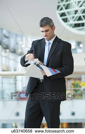 Businessman tearing up a document View Large Photo Image Stock Photo - Businessman tearing up a document. Fotosearch