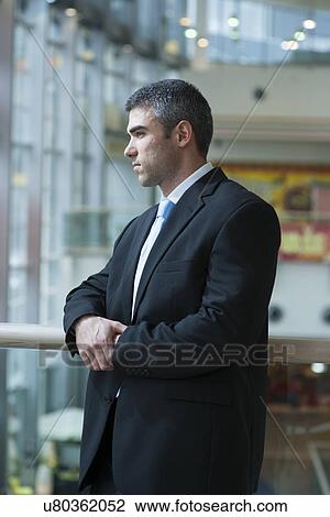 Businessman with serious expression looking off camera View Large Photo Image Stock Image - Businessman with serious expression looking off camera. Fotosearch